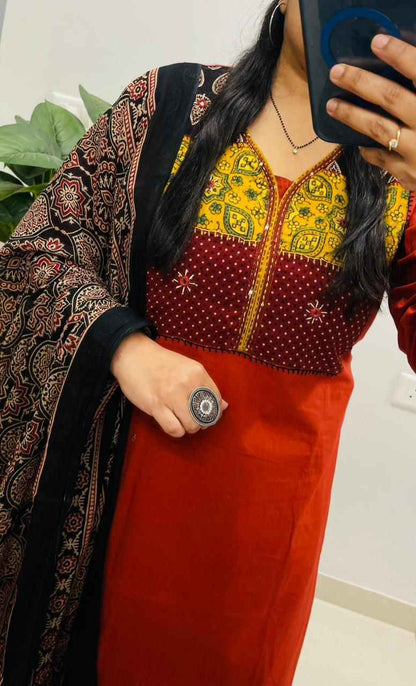 Side perspective presentation of the fully stitched red ethnic tunic highlighting the clean tailored borders and regular forty six plus inch length outline.