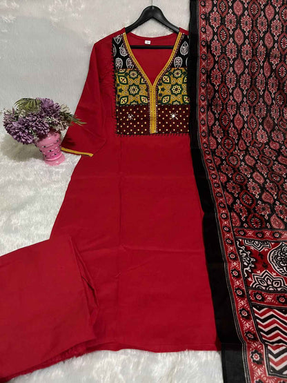 Close up view of traditional neckline hand work embroidery and crisp red traditional patterns on a pure cotton kurta bodice.