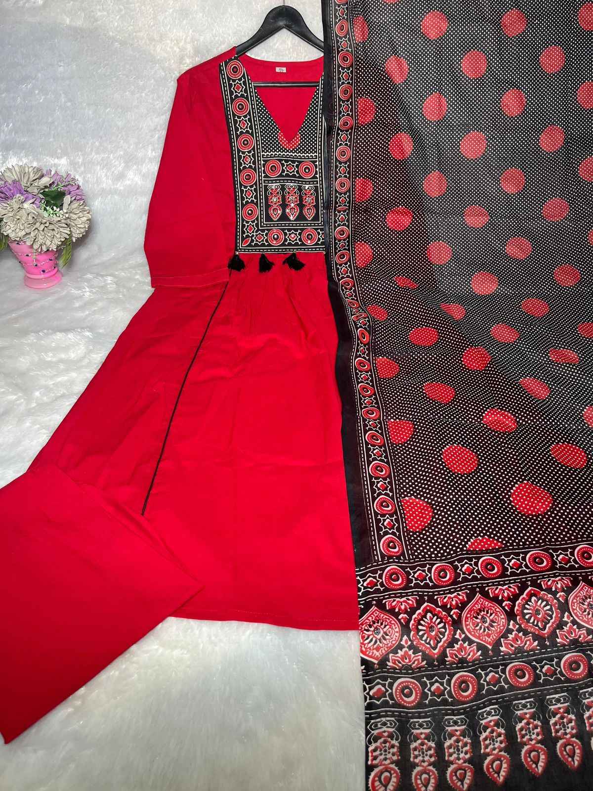 Side perspective presentation of the fully stitched red ethnic top highlighting the clean tailored seams and standard regular straight fit outline.