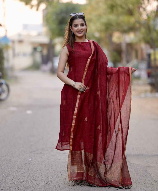 Front view of full three piece maroon sulabh cotton a line kurti set displaying a sleeveless halter neck tunic palazzo pants and weaved linen dupatta.