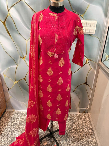 Close up view of detailed ethnic discharge print patterns and fine yoke highlighting lines on a rich dark pink cotton fabric bodice.