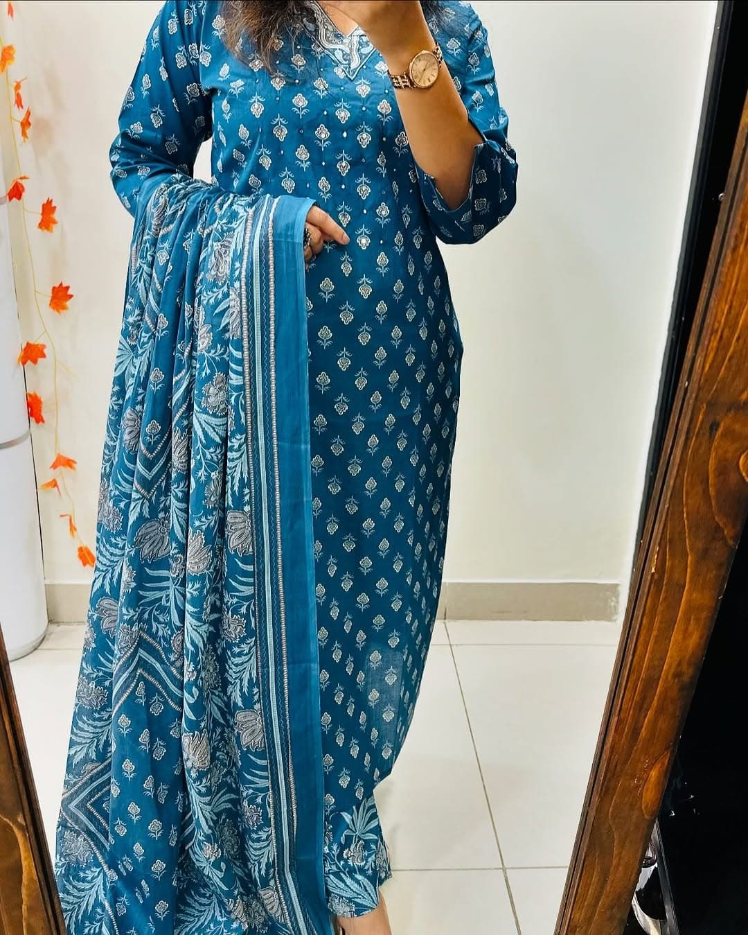 Close up view of detailed traditional hand work and premium intricate thread embroidery patterns on a bright blue heavy cotton kurta bodice.