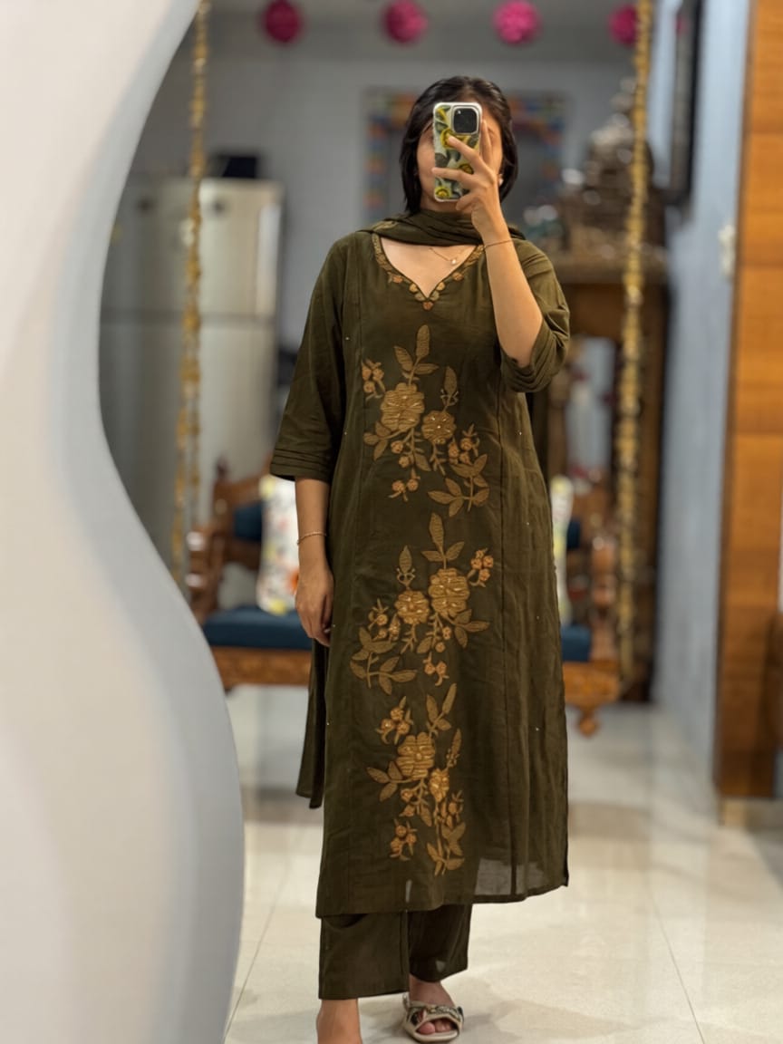Front view of full three piece olive green kalamkari fusion suit set displaying an embroidered heavy cotton kurti straight pants and mal cotton dupatta.