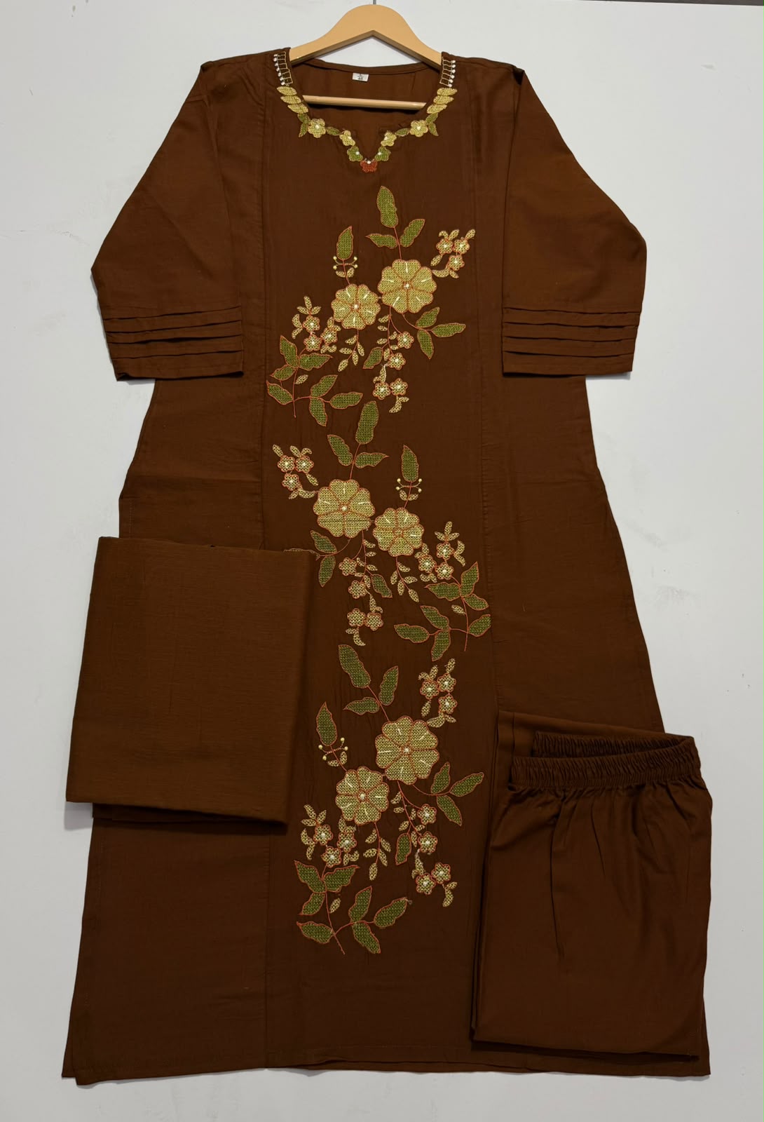 Side perspective presentation of the fully stitched klosia brown ethnic tunic highlighting the clean tailored seams and forty six inch regular fit length.