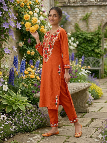 Front close view of the matching rust orange cotton palazzo pants showing the relaxed wide leg opening and clean structural stitching lines.