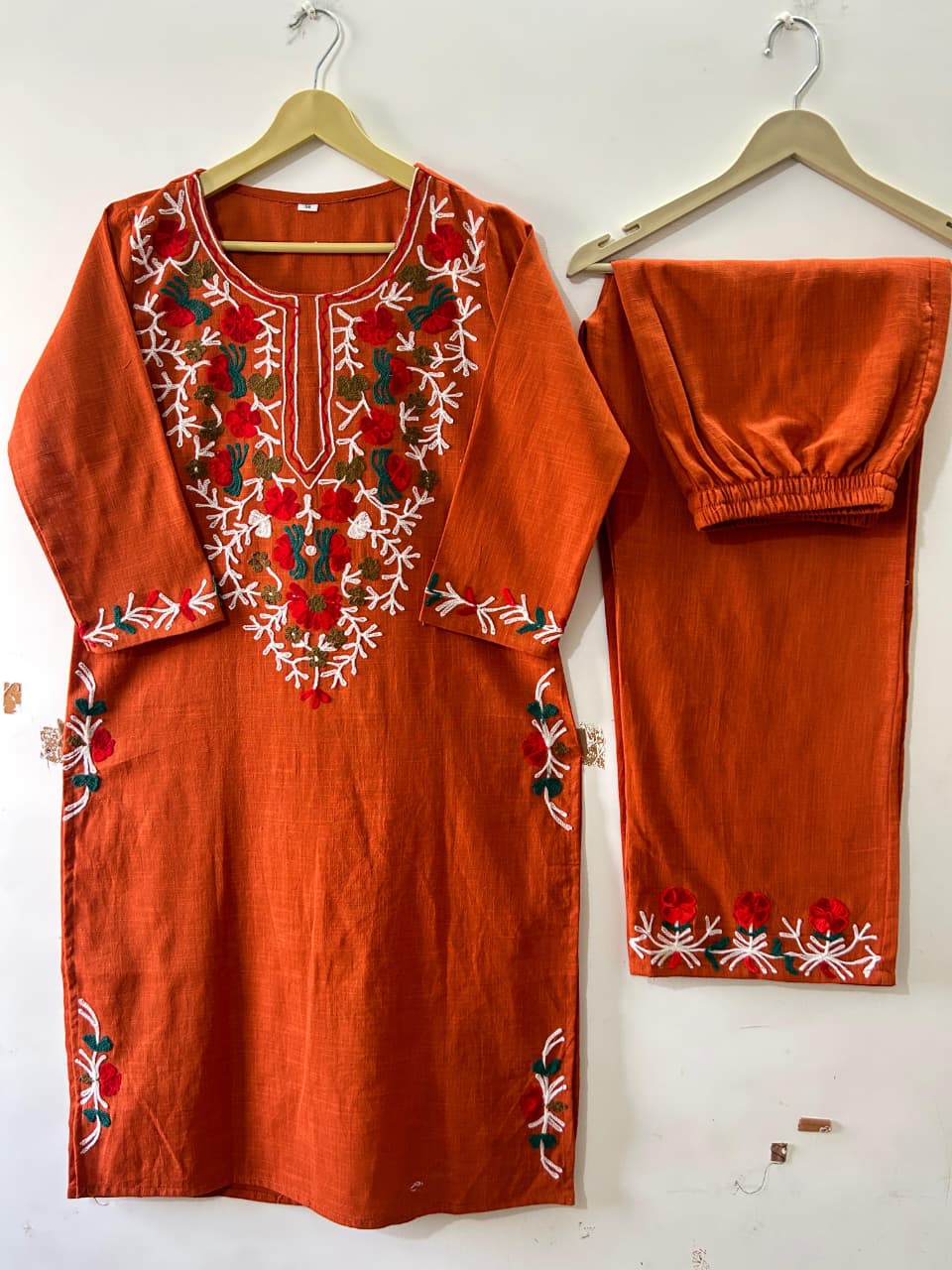 Side perspective presentation of the fully stitched rust orange ethnic top highlighting the clean tailored seams and standard regular fit outline.