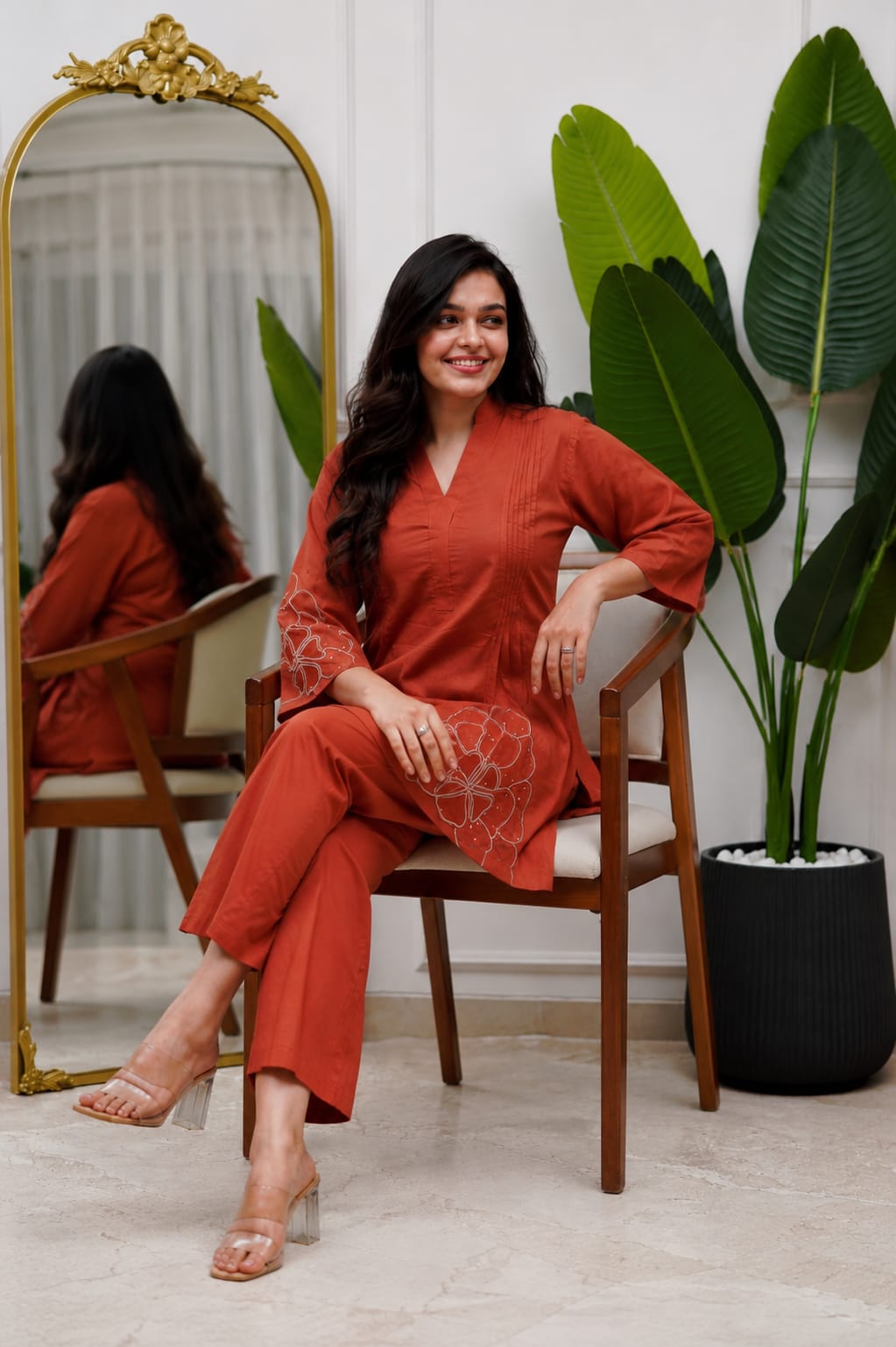 Side perspective presentation of the fully stitched rust orange casual tunic highlighting the clean tailored seams and relaxed regular fit line