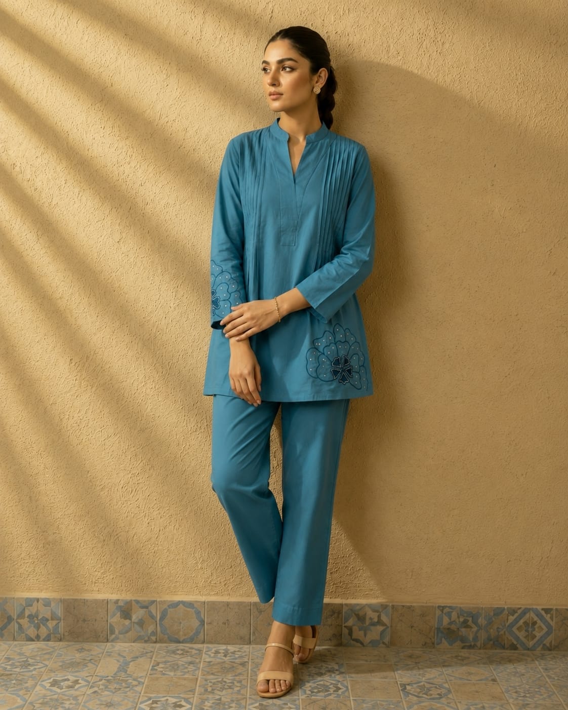 Front view of full two piece tea blue premium cotton embroidered palazzo set displaying a beautifully embroidered tunic top and matching wide leg trousers.