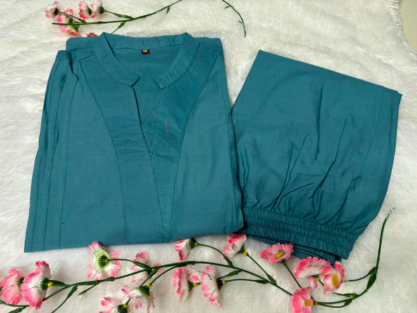 Side perspective presentation of the fully stitched tea blue casual tunic highlighting the clean tailored seams and relaxed regular fit line.