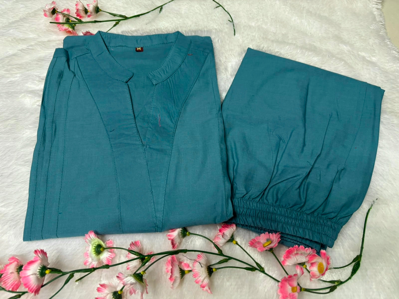Side perspective presentation of the fully stitched tea blue casual tunic highlighting the clean tailored seams and relaxed regular fit line.