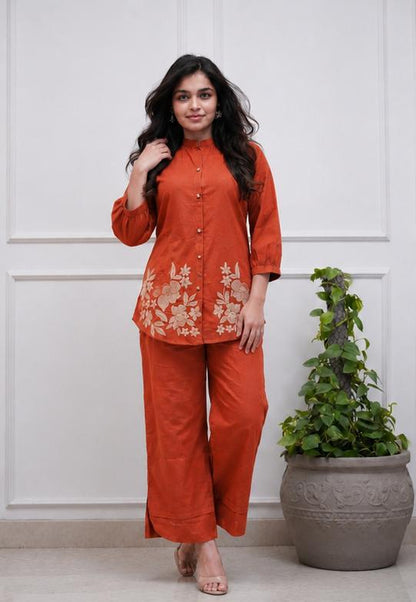 Front view of full two piece rust orange premium cotton embroidery co ord set displaying a beautifully embroidered tunic top and matching straight trousers.