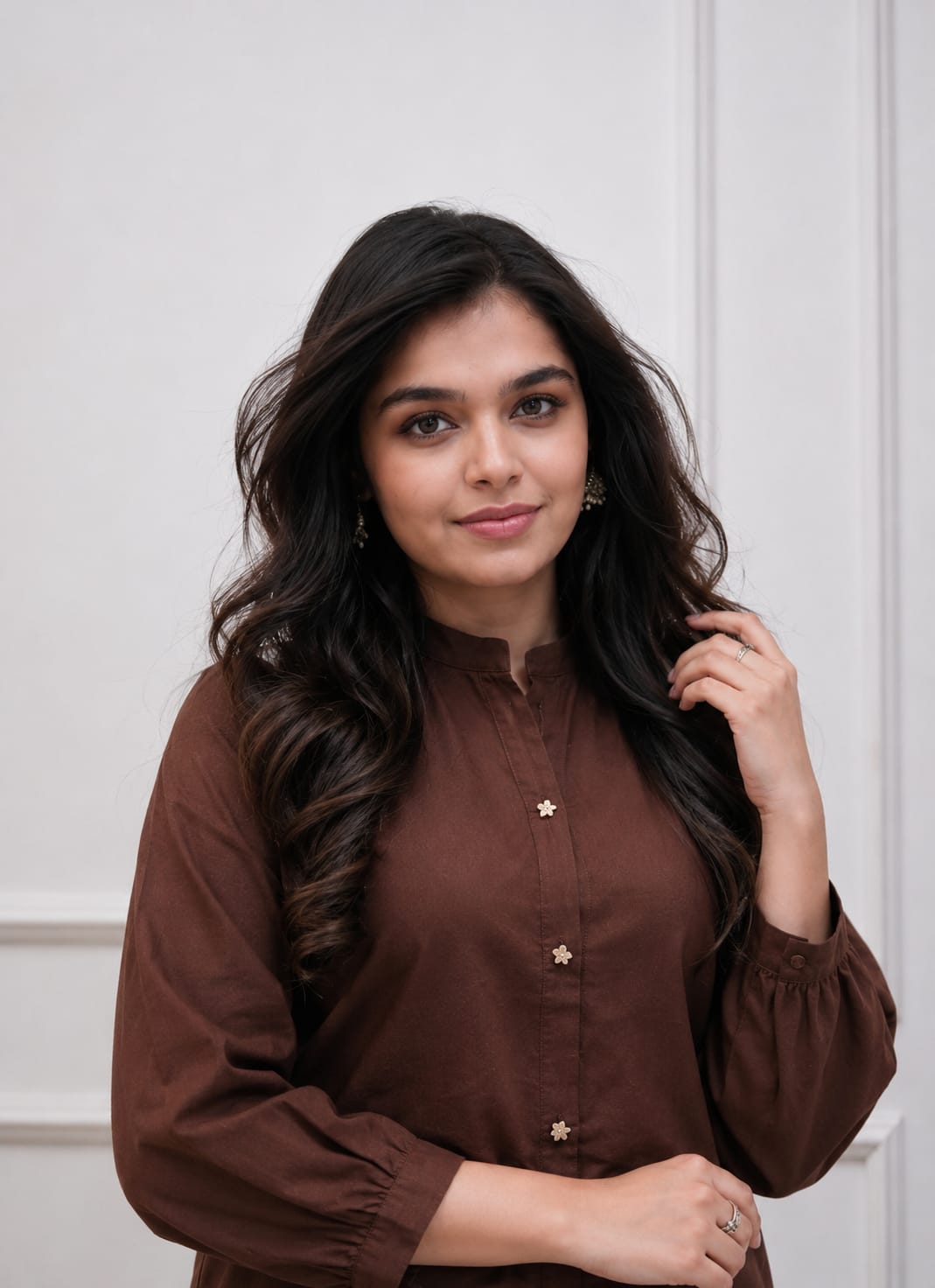 Close up view of detailed traditional embroidery work and high quality thread work patterns on a deep coffee brown cotton fabric bodice canvas.