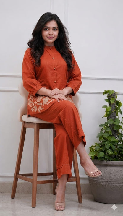 Side perspective presentation of the fully stitched rust orange casual tunic highlighting the clean tailored seams and relaxed regular fit line.