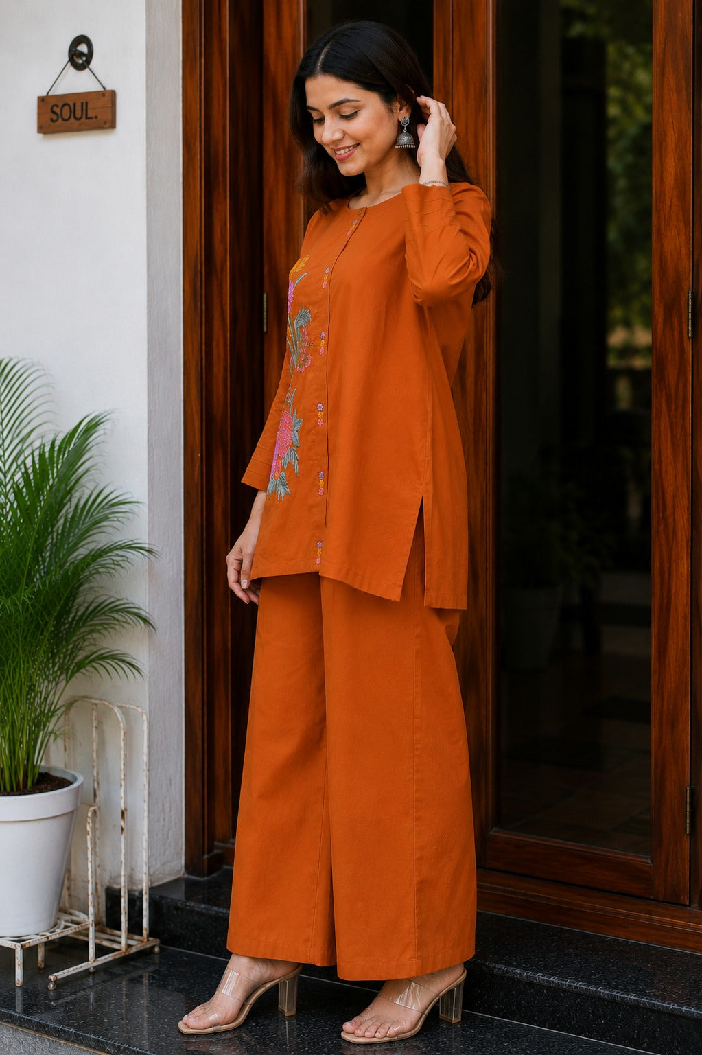 Back angle presentation of the rust orange premium cotton top showing the continuous solid color layout and clean seamless structure lines.