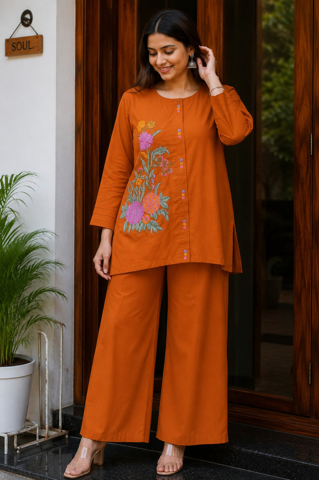 Front view of full two piece rust orange premium cotton embroidered co ord set displaying a beautifully embroidered tunic top and matching straight trousers.