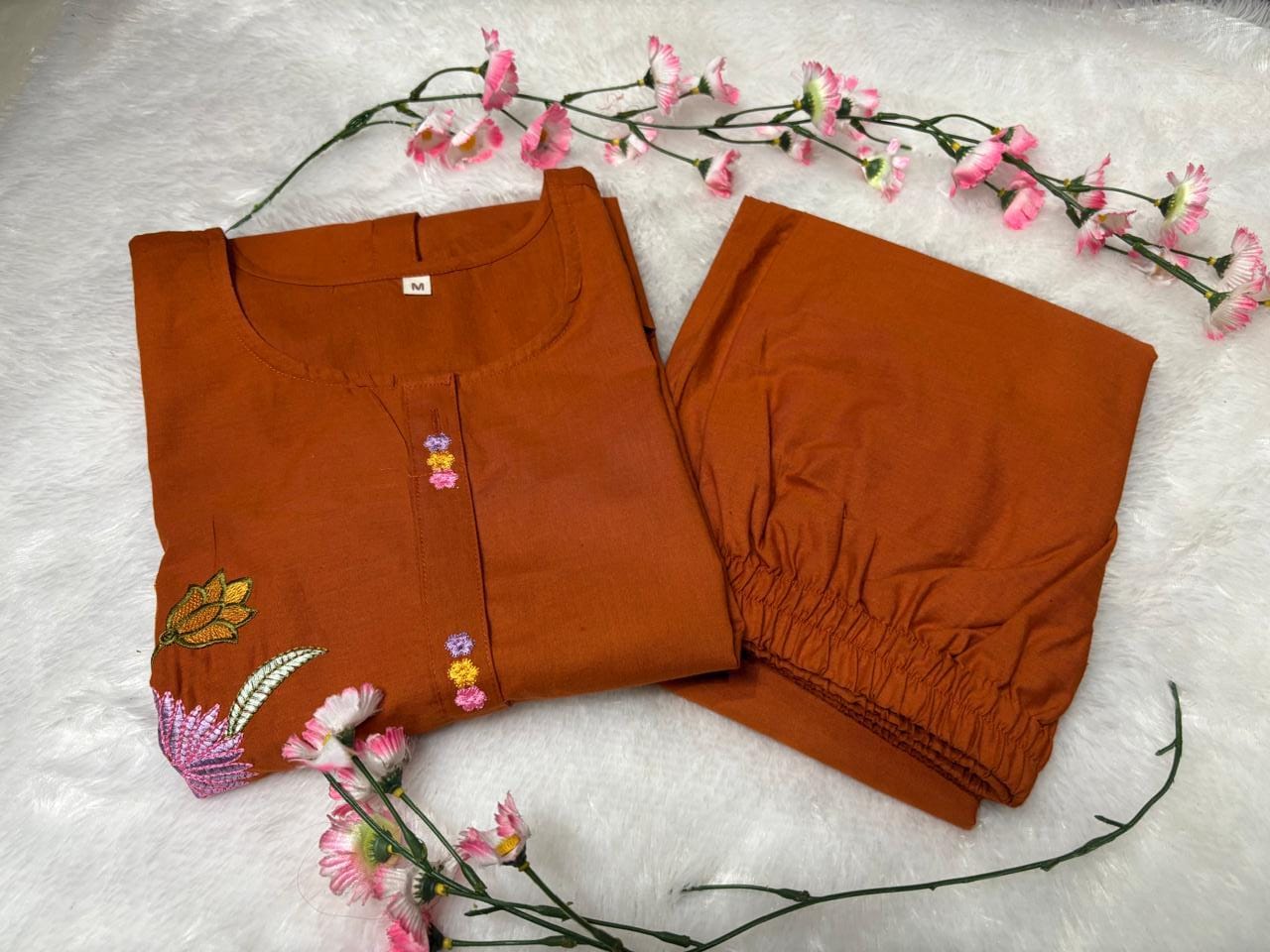 Side perspective presentation of the fully stitched rust orange casual tunic highlighting the clean tailored seams and relaxed regular fit line.