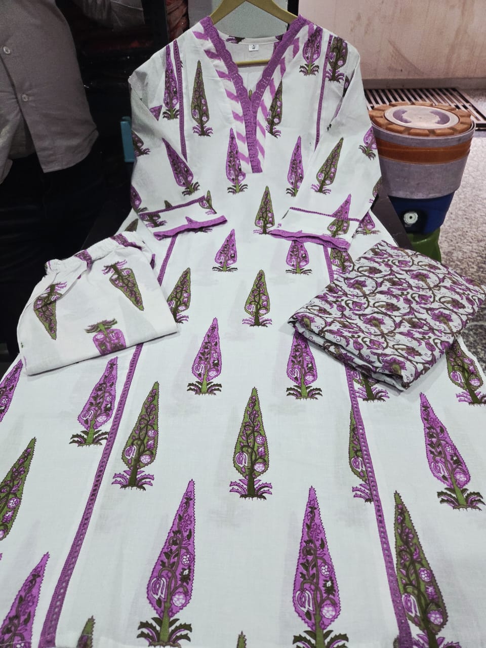 Detailed presentation of the purple sleeve cuffs showing the intricate lace borders and premium tailoring lines on the straight fit arm profile.