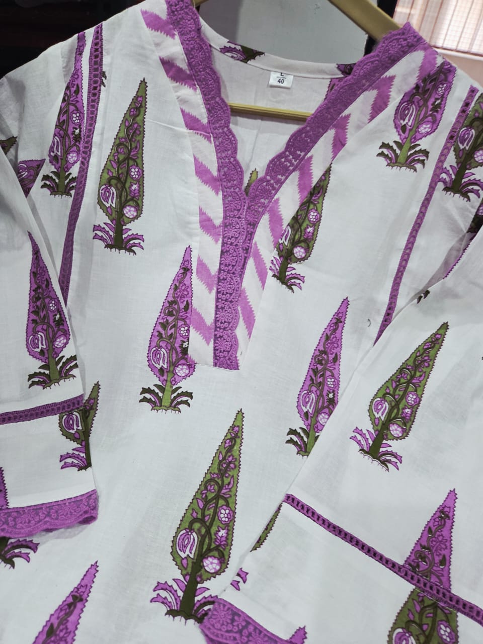 Detailed presentation of the purple sleeve cuffs showing the intricate lace borders and premium tailoring lines on the straight fit arm profile.