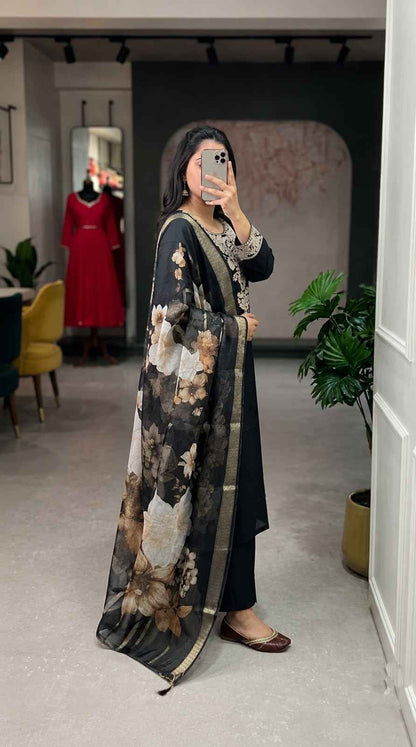 Side perspective presentation of the fully stitched black luxury tunic highlighting the clean tailored seams and calf length forty four plus inch outline.