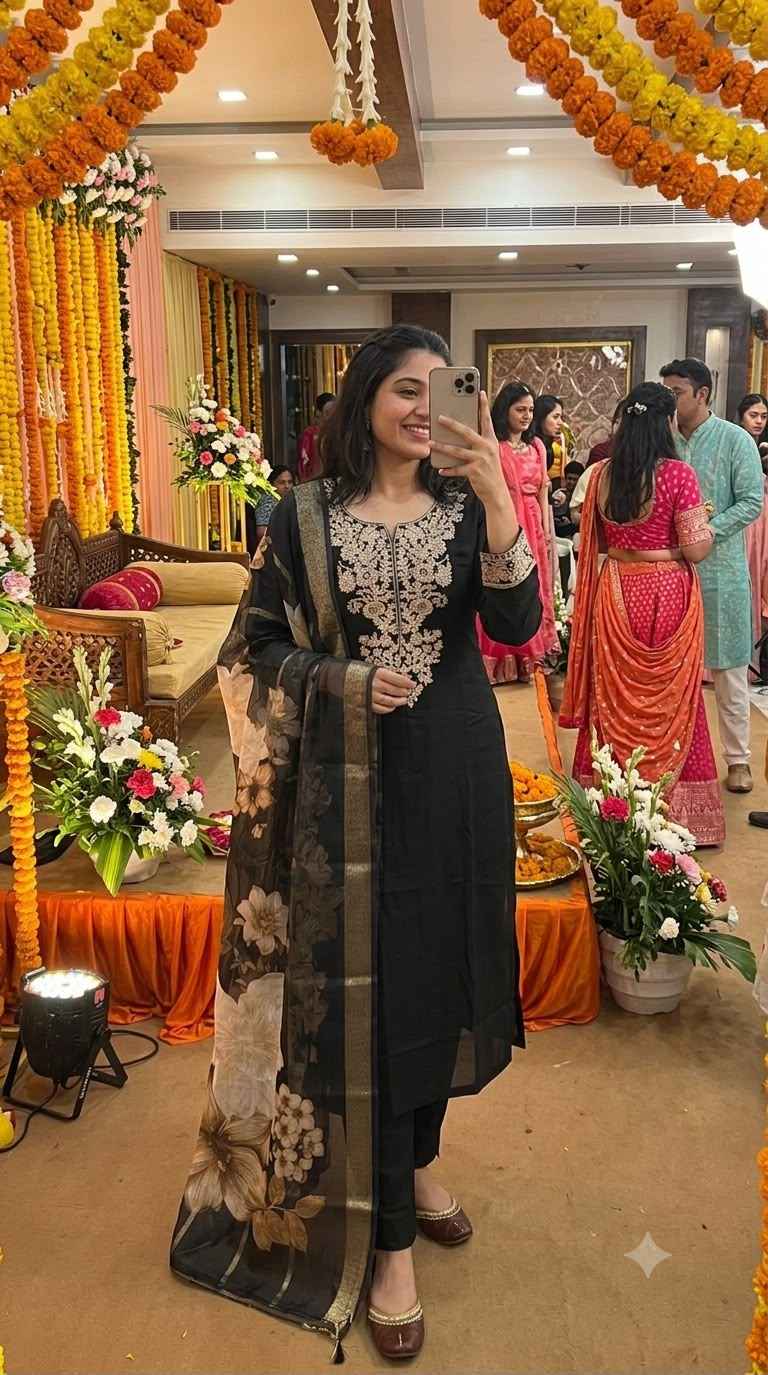 Front view of full three piece black embroidered roman silk kurta set displaying the heavy embroidered top trousers and digital print chanderi dupatta.