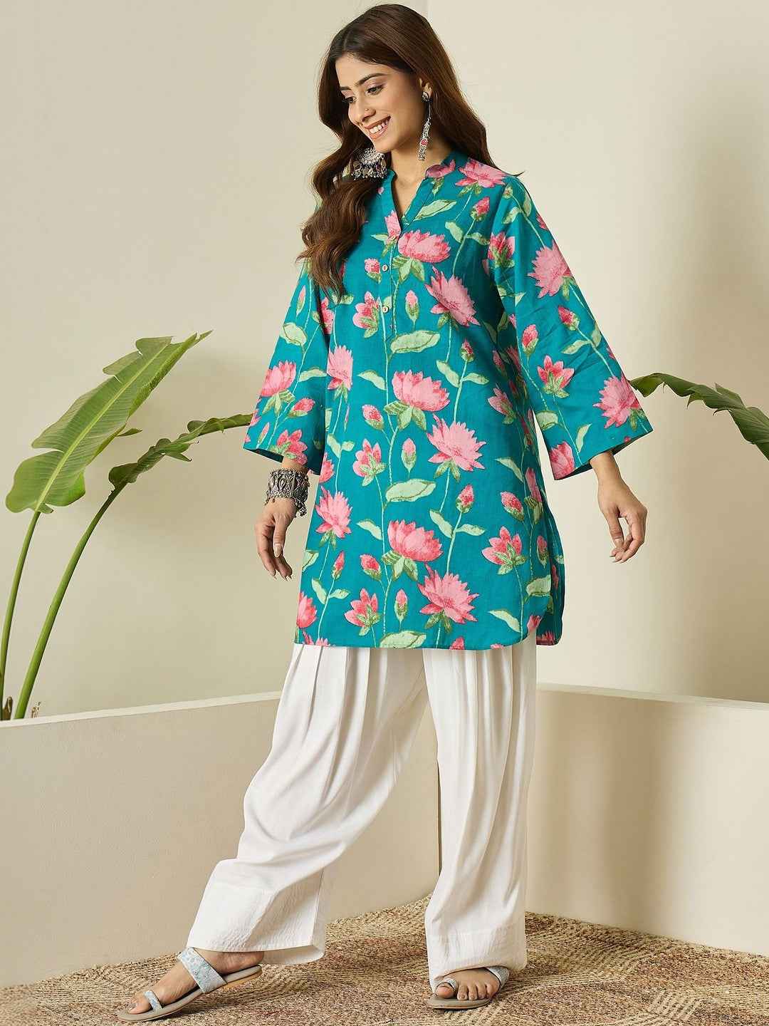 Close up view of detailed traditional printing patterns on a rich deep cyan imported cotton fabric bodice canvas.