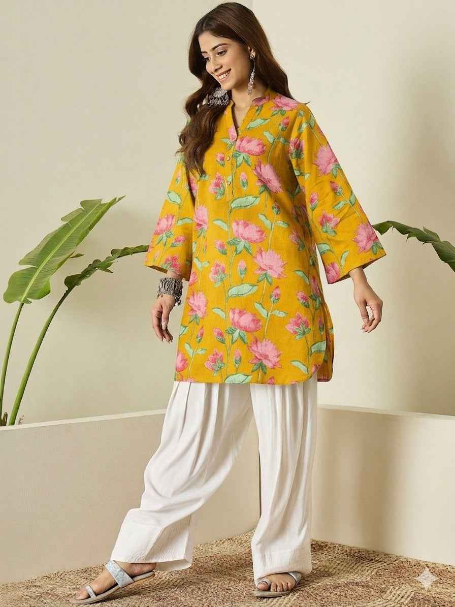 Front view of full two piece yellow breathable kurta farshi salwar set displaying a printed short tunic and flared trousers.