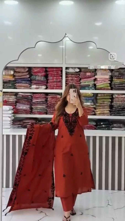 Front view of full three piece maroon flared cotton a line kurti set displaying an embroidered top straight pants and heavy dupatta.