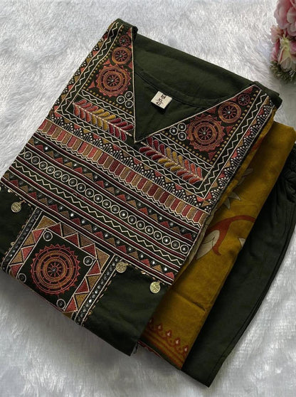 Close up view of detailed traditional thread embroidery work and intricate weaving patterns on a vibrant green pure cotton fabric yoke panel.