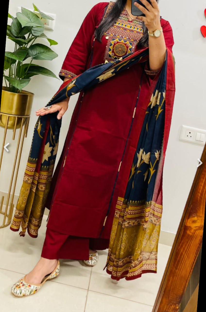Front view of full three piece maroon pure cotton embroidery suit set displaying the embroidered yoke top trousers and matching full dupatta.