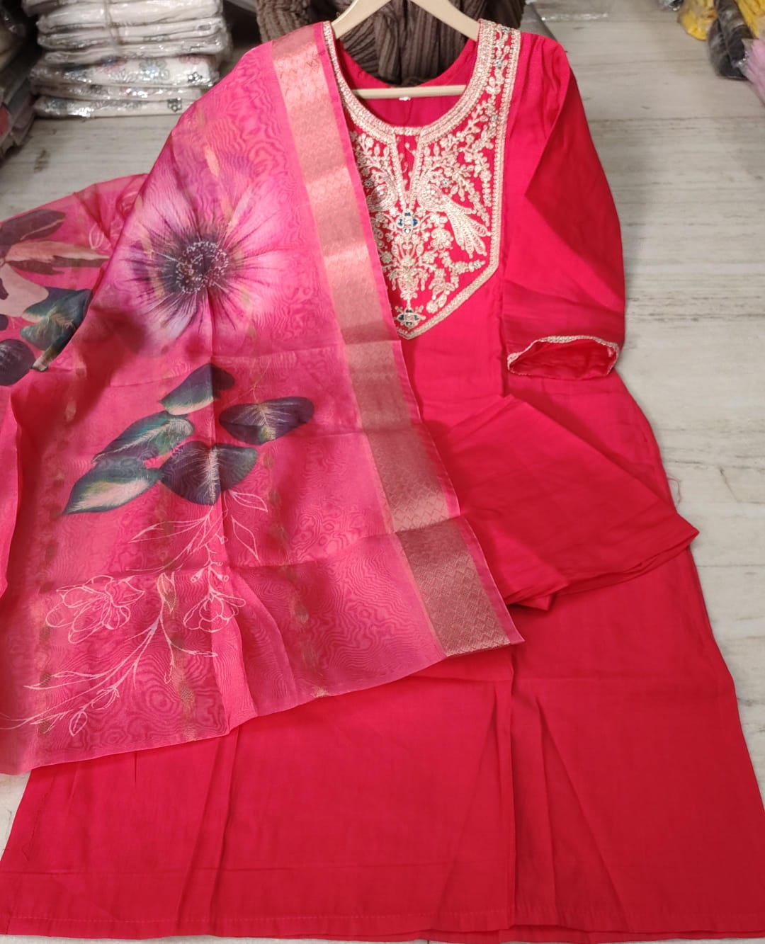 Close up view of intricate heavy embroidery work and fine stitching on a dark pink Roman silk tunic yoke panel - WishTown Fashion Club