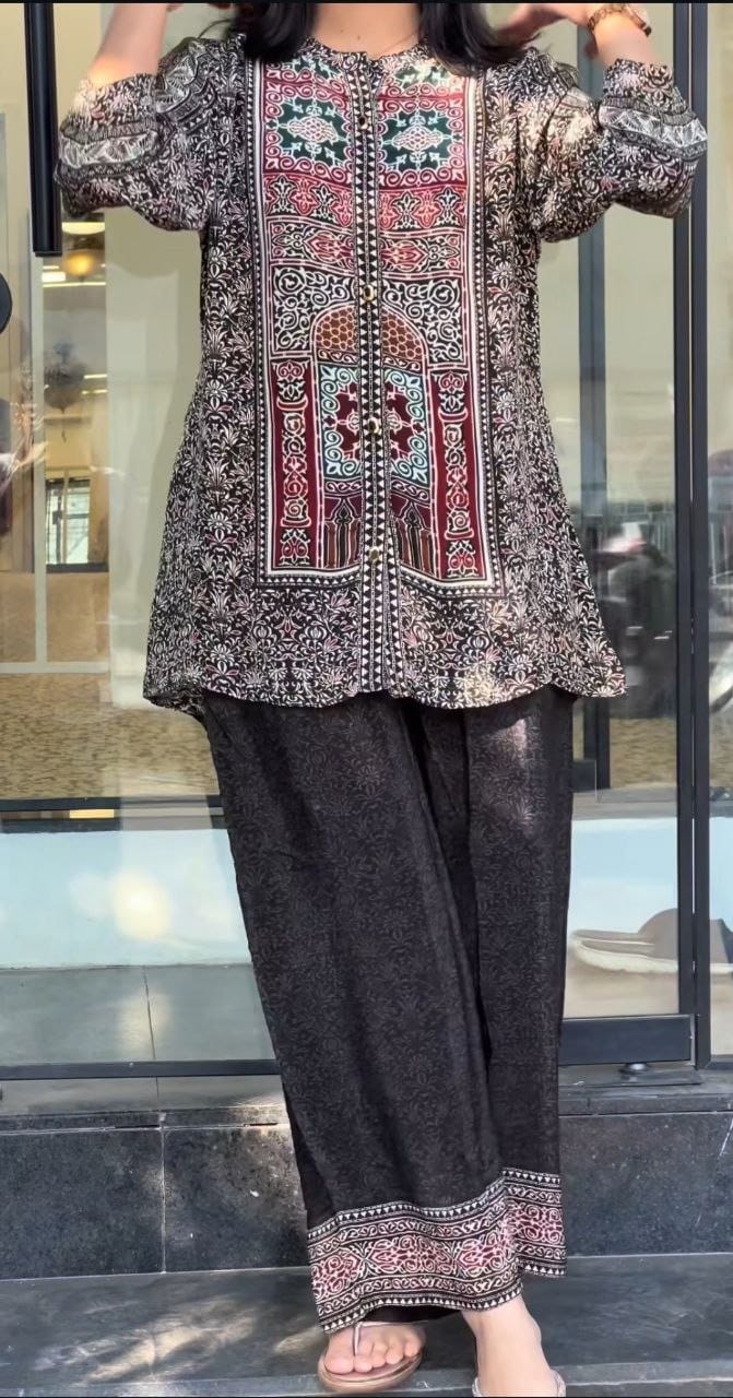 Front view of designer two piece light black pure natural crape co ord set displaying matching tunic top and wide leg palazzo pants