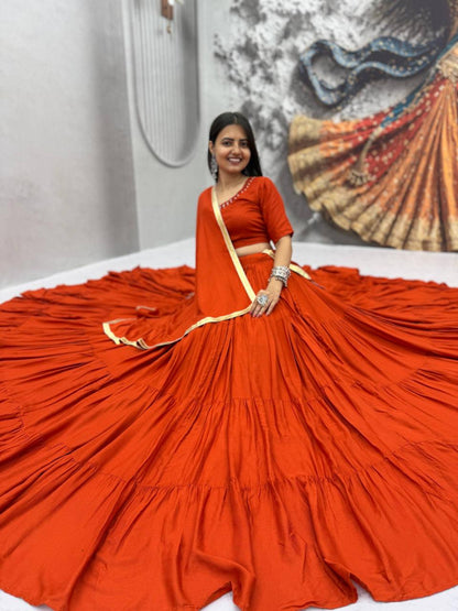 Front view of full three piece orange rayon cotton handmade mirror work lehenga choli with flared skirt padded blouse and dupatta - WishTown Fashion Club