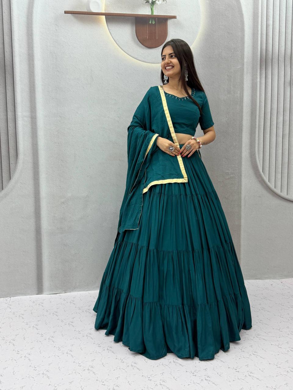 Front view of full three piece bottle green rayon cotton handmade mirror work lehenga choli with flared skirt padded blouse and dupatta - WishTown Fashion Club