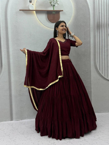 Front view of full three piece maroon rayon cotton handmade mirror work lehenga choli with flared skirt padded blouse and dupatta - WishTown Fashion Club