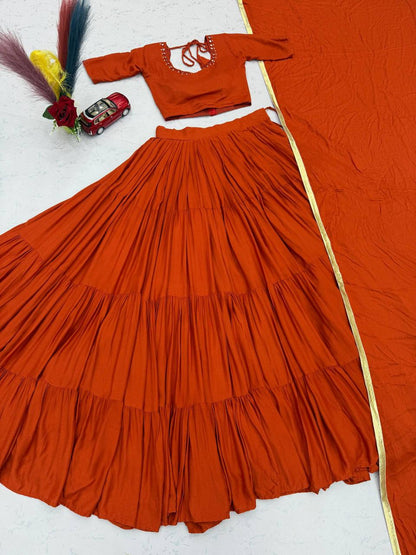 Close up view of detailed real handmade mirror work embroidery and fine stitching on orange choli bodice panel - WishTown Fashion Club
