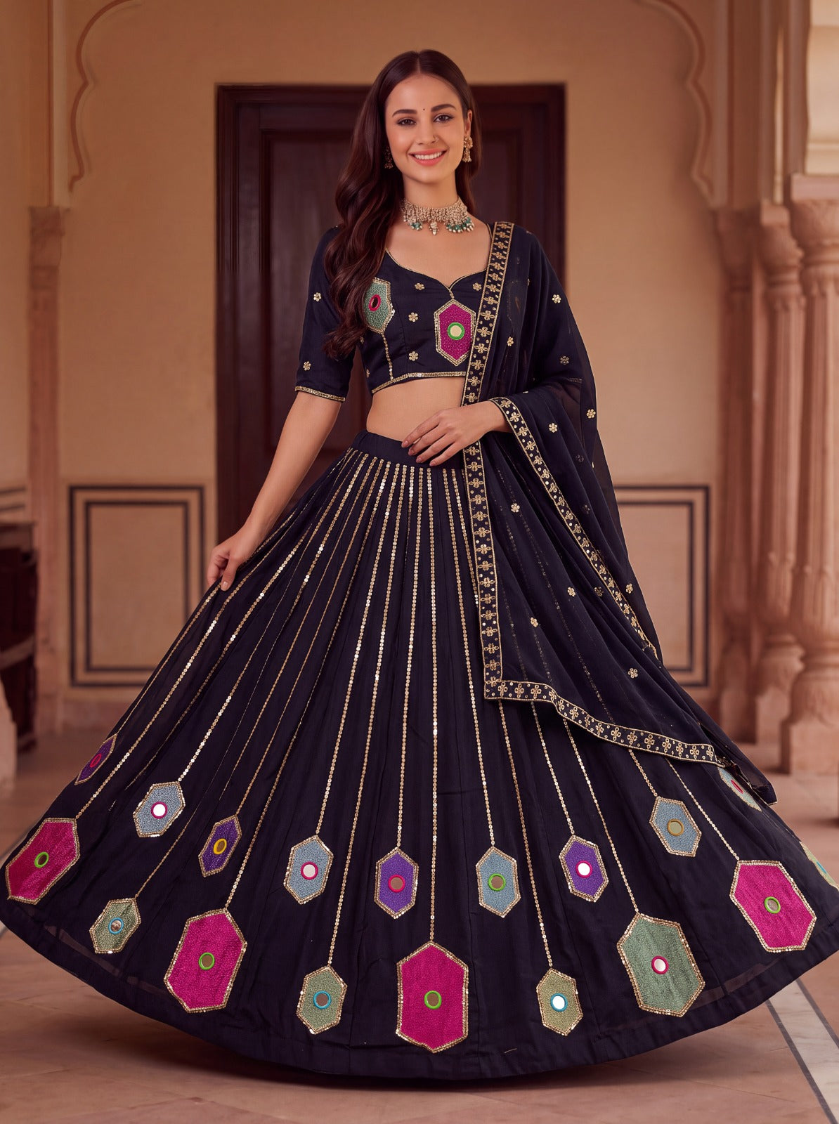 Close up view of vibrant embroidery work and real hand mirror details on black rayon lehenga panels - WishTown Fashion Club