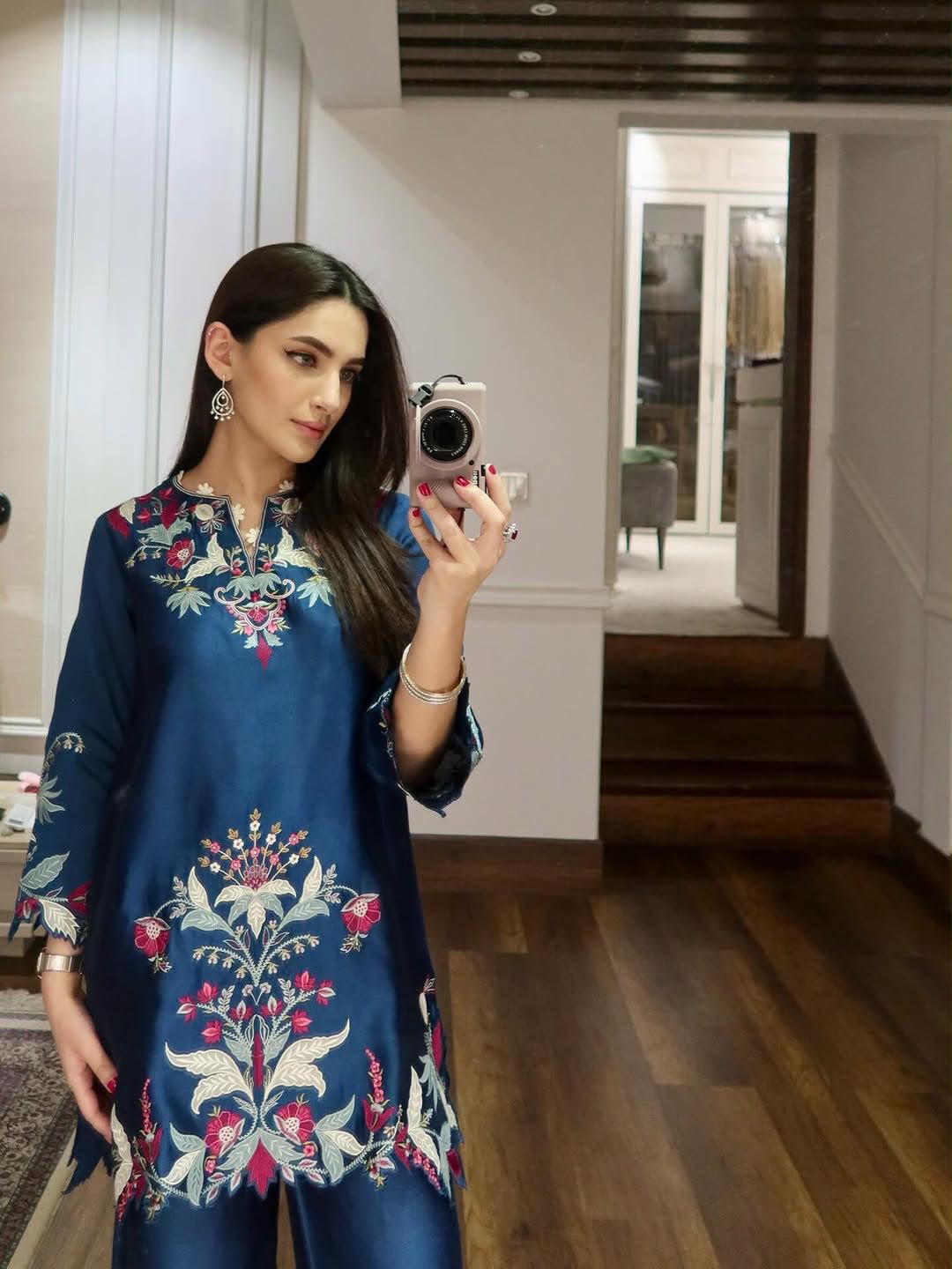 Close up view of delicate cut work and intricate embroidery on blue French crape top hem - WishTown Fashion Club