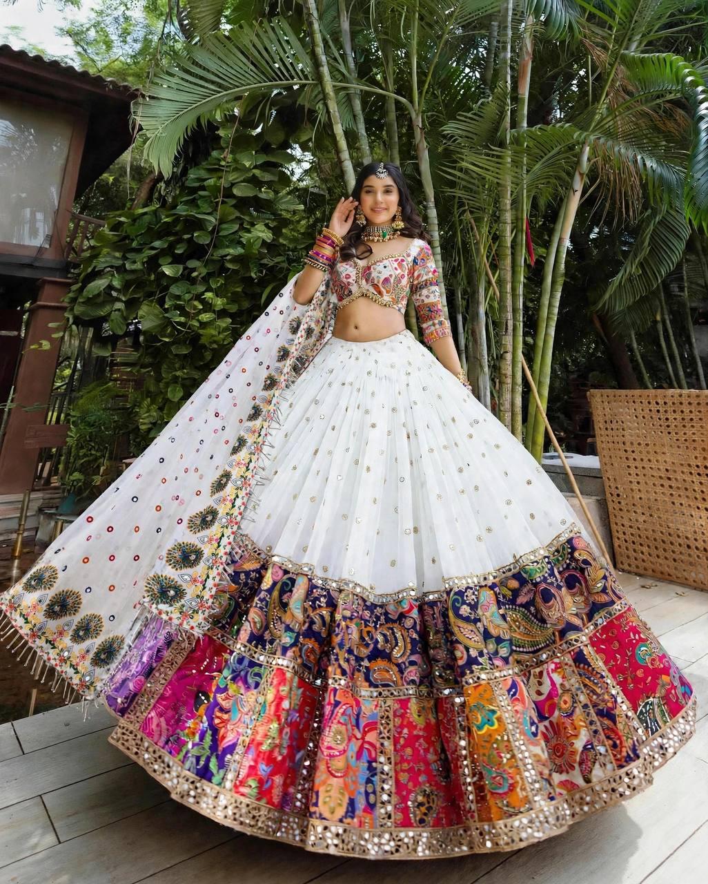 Close up view of real mirror work digital prints and tassels on white muslin silk lehenga panels - WishTown Fashion Club