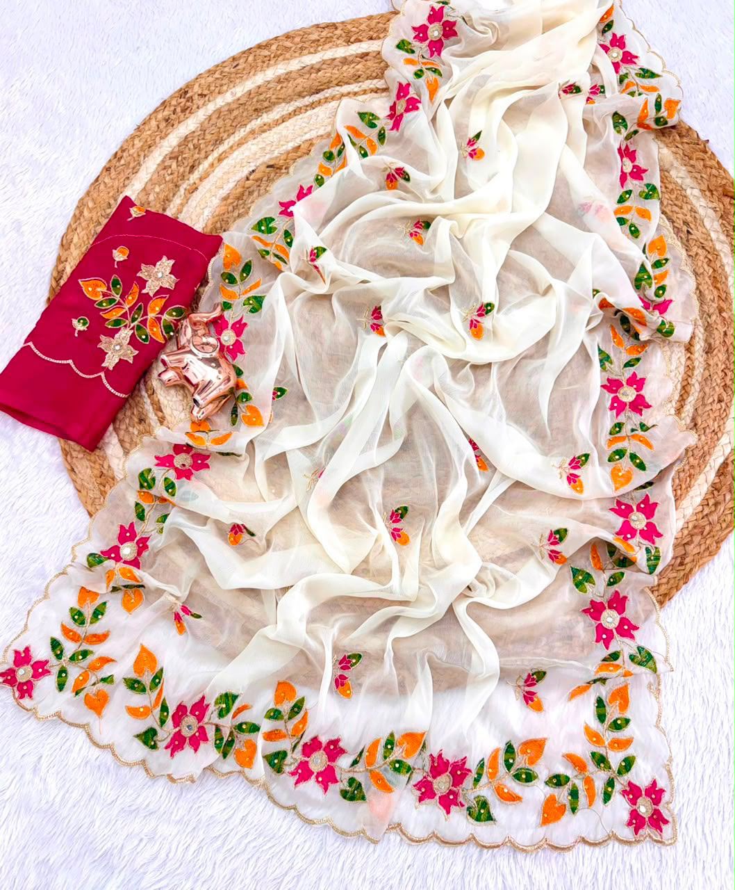 Close up view of rich allover embroidery and sparkling diamond embellishments on white georgette saree - WishTown Fashion Club