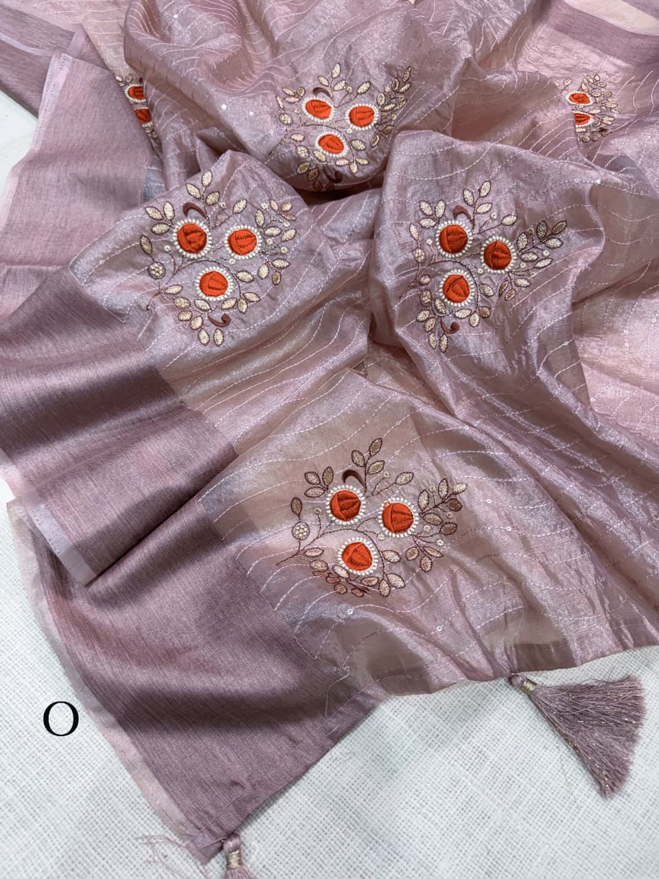 Close up view of intricate blade cutwork edging on shimmering onion pink tissue silk saree - WishTown Fashion Club