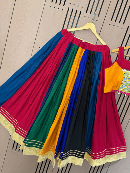 Model wearing multi colour rayon mirror work gotta patti lehenga choli showcasing Garba dance twirl - WishTown Fashion Club