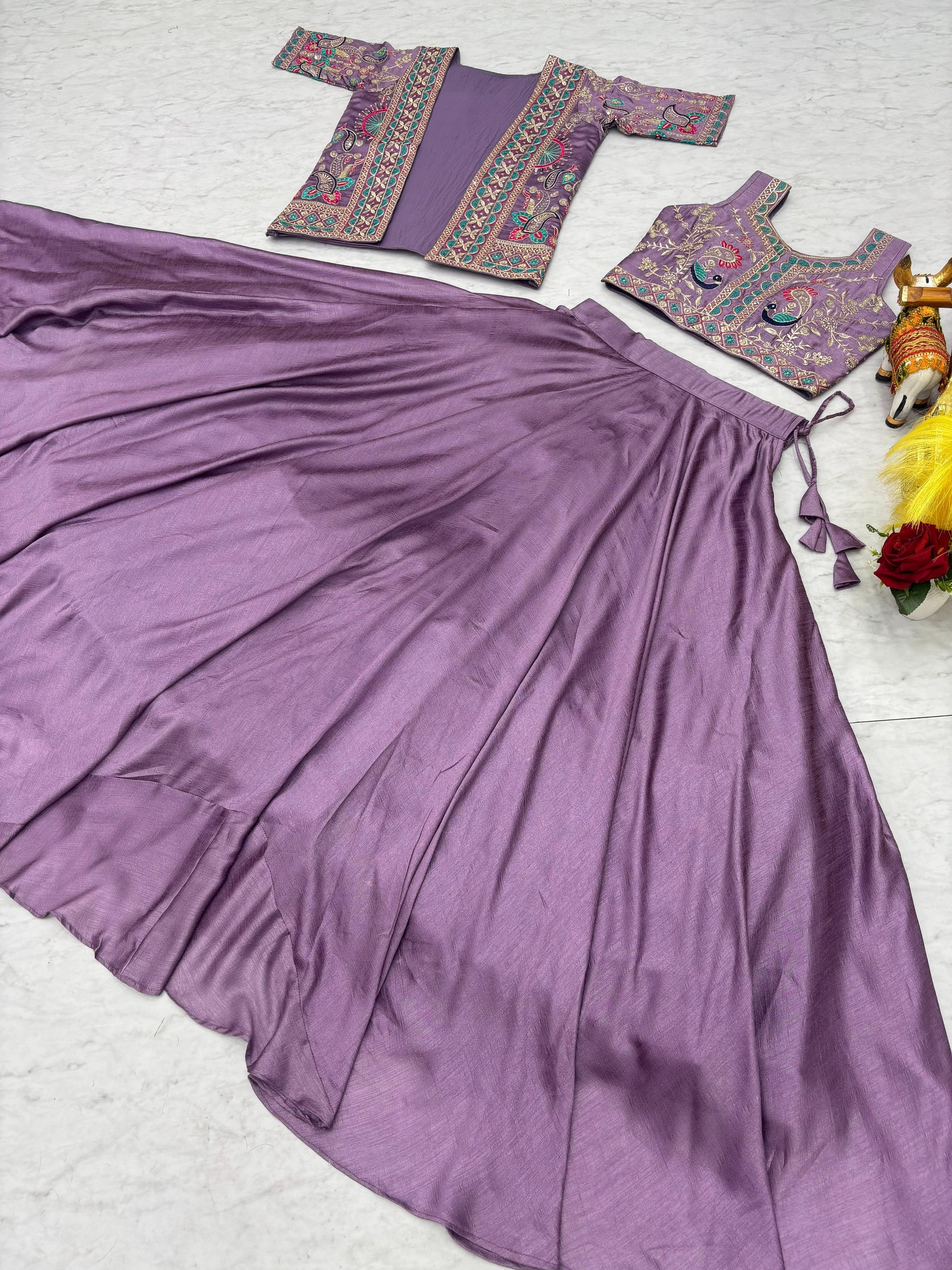 Macro view of delicate needlework and premium thread craftsmanship on smooth lavender festive attire fabric.