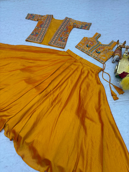 Close up details of intricate thread embroidery patterns on premium smooth mustard yellow silk fabric.