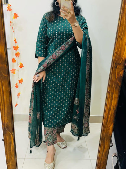 Close up view of intricate handcrafted needlework patterns and premium stitching details on high quality teal green cotton fabric.