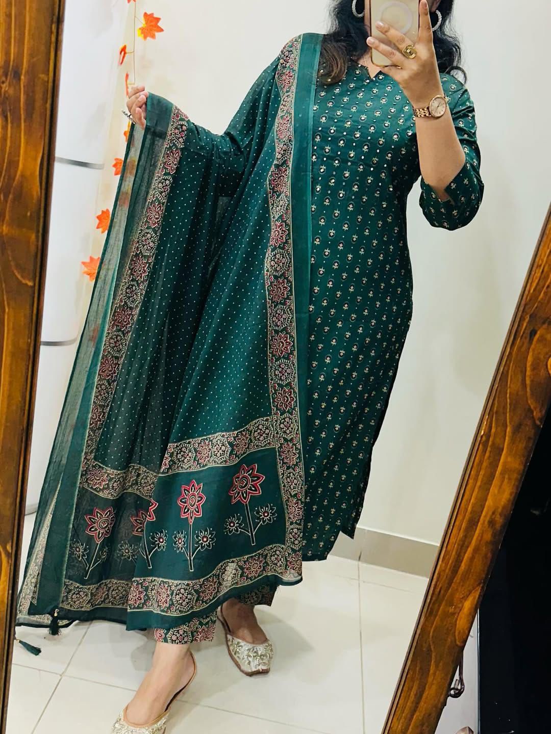 Front view of full three piece teal green traditional outfit featuring hand embroidered cotton tunic and matching straight pants.
