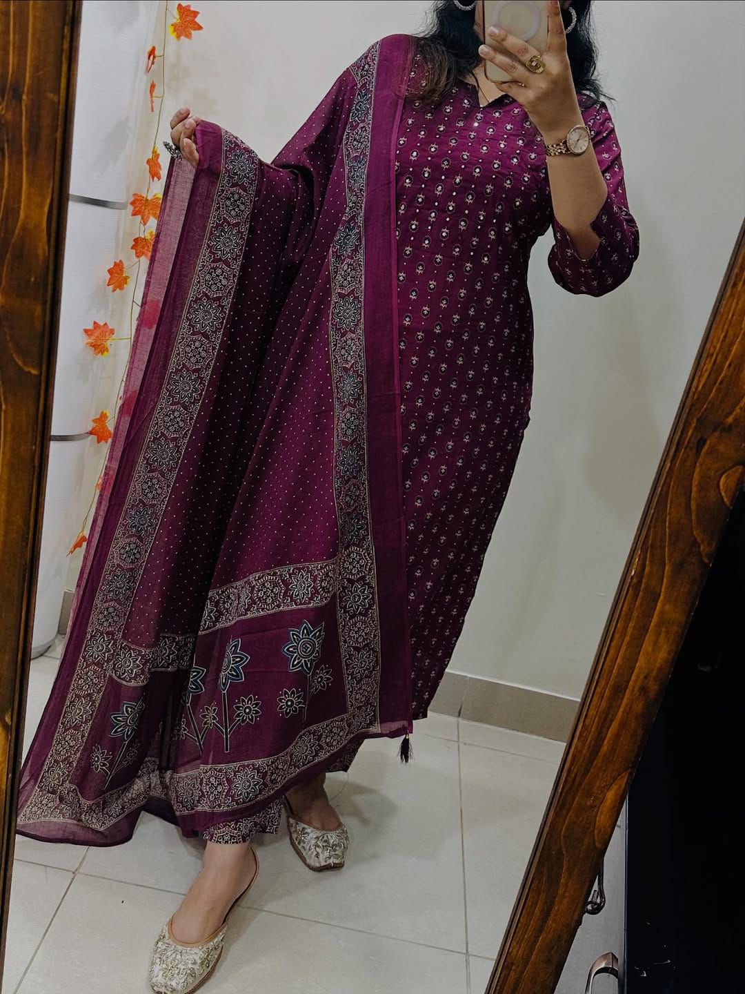 Full length presentation of a rich wine red traditional three piece suit displaying long top and tailored trousers.