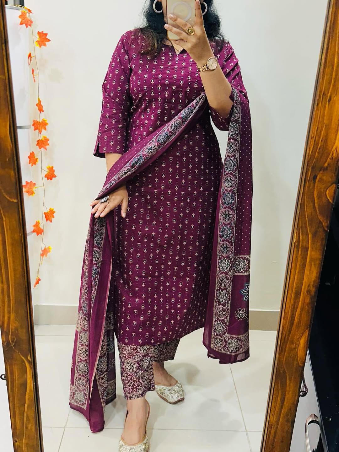 Side angle view of a wine color traditional ensemble showcasing the lightweight drape of premium mul mul fabric.
