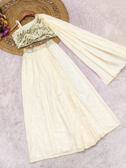 Close up view of colorful multi thread embroidery patterns and glittering sequence work on a cream crape silk bodice.