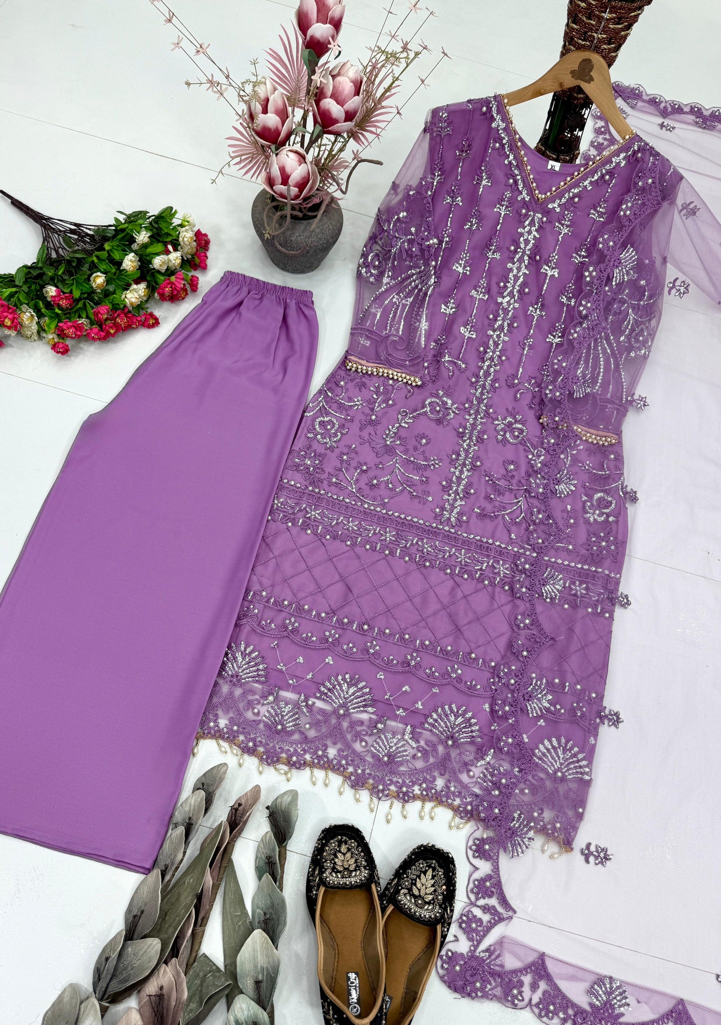 Side profile view of a purple traditional ensemble showcasing the lightweight drape of premium net fabric and long sleeve details.