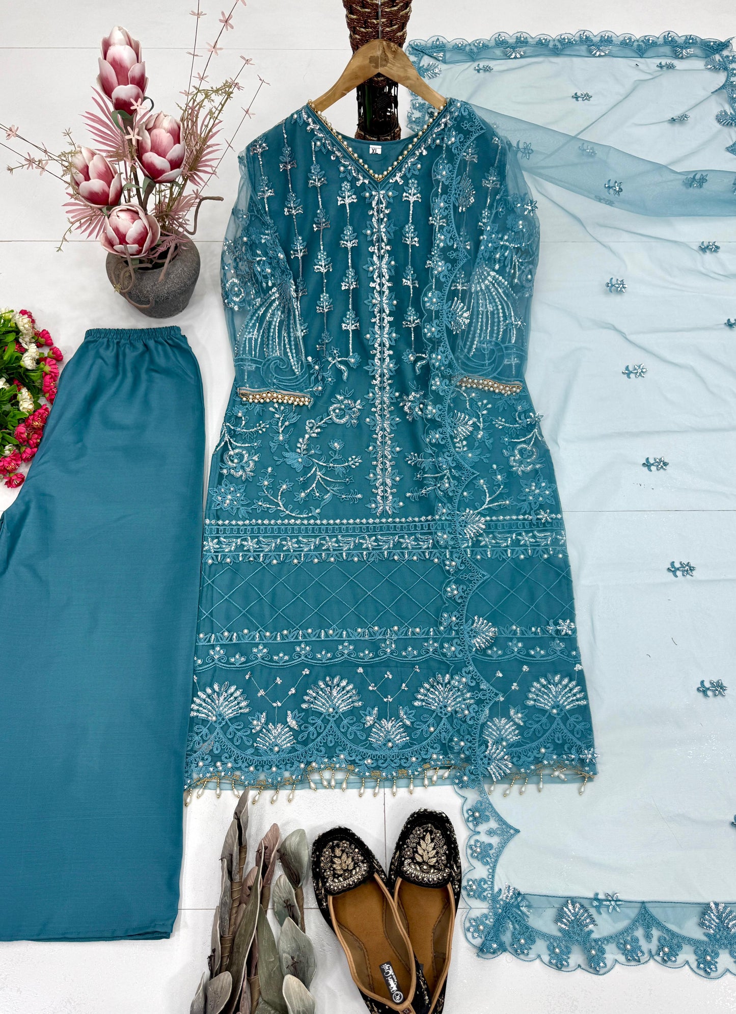 Back perspective of fully stitched teal blue ethnic suit highlighting the comfortable straight silhouette and soft micro cotton texture.